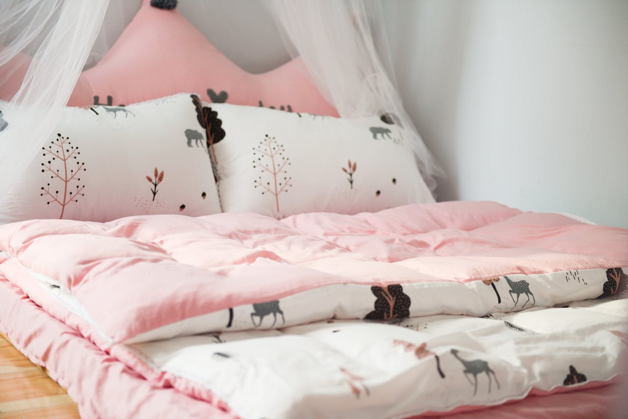 portfolio-img-04 A cozy bedroom with pink bedding and animal patterns, perfect for relaxation.